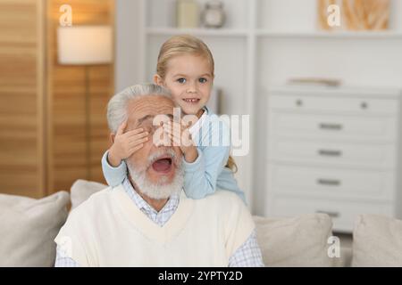 Grandpa and his granddaughter having fun at home Stock Photo