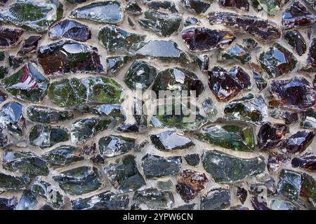 Glass fiber melt multicolored blocks cemented on facade wall as modern decorative decision of broken glass recycling.  Stock Photo