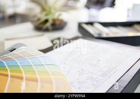Interior designer's working table, an architectural plan of the house, a color palette, furniture and fabric samples. Drawings and plans for house dec Stock Photo