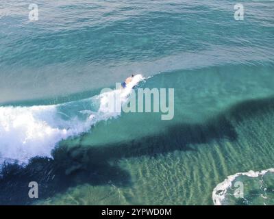 Aerial view of surfers waiting, paddling and enjoying waves in a beautiful blue water in La Jolla, San Diego, California, USA. July 1st, 2019 Stock Photo