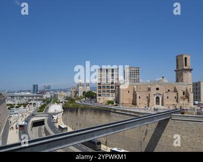 Eglise St.-Laurent is a roman church at the entrance of the old harbour of Marseille, France. Front of the church surrounded by modern housing blocks Stock Photo