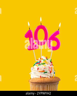 Pink number 106 birthday candle lit on white background Stock Photo - Alamy