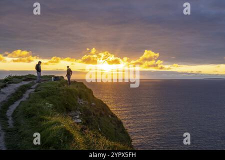 Cliffs of Moher, cliffside hiker, The Burren, County Clare, Ireland, United Kingdom, Europe Stock Photo