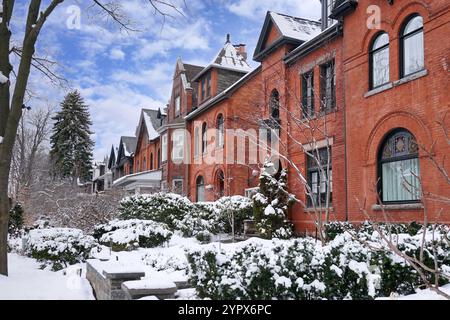 Urban residential street with red brick houses after a snow storm Stock Photo