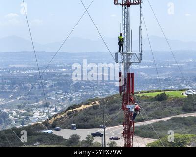 Engineer with safety equipment on high tower for working telecom communication maintenance. San Diego, South California, USA. September 21st, 2022 Stock Photo