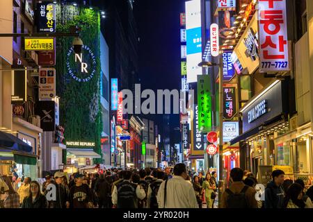 Seoul, South Korea - October 26 , 2024: Street scene of the bustling and vibrant shopping district Myeong-Dong at night with illuminated signs, locate Stock Photo