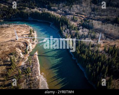 Natural gas pipeline crossing over a river on an industrial suspension bridge in Southern Alberta Canada. Stock Photo