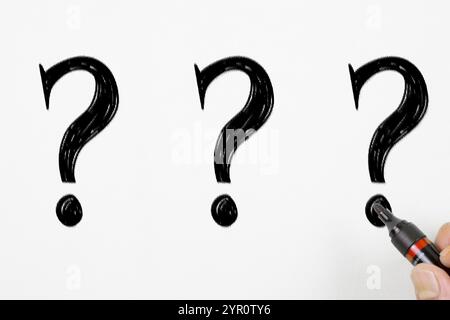 Question marks written on White Background Stock Photo