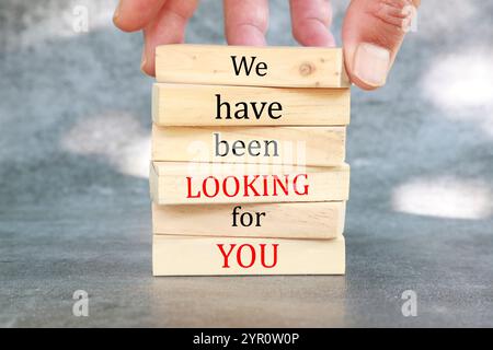 We have been looking for you symbol. Wooden blocks with words We have been looking for you. Beautiful sunlit grey background. Business and We have bee Stock Photo