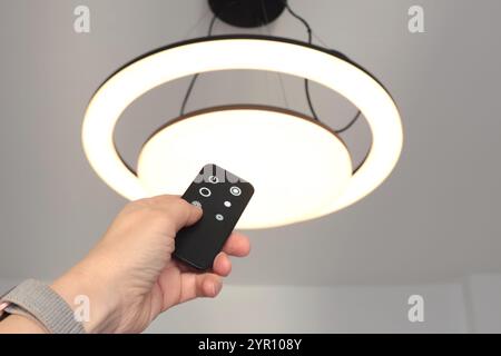 LED ceiling light with smart remote control. Energy saving. Clean planet and environmental protection.  Stock Photo