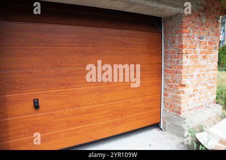 Close up on installing garage door boards in new brick house construction. Stock Photo