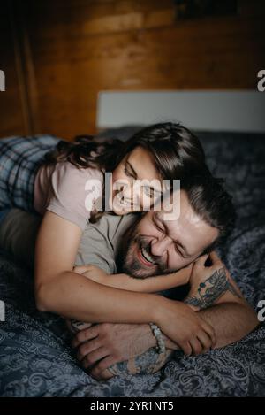 Embracing young couple on the bed closeup. Stock Photo