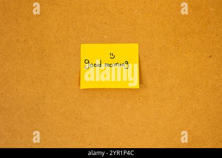 Concept of yellow note stuck on a board with good morning message Stock Photo