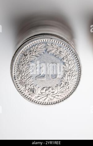 A stack of 20 Rappen Swiss Franc currency coins. Top view, isolated on white, close up shot, no people. Stock Photo