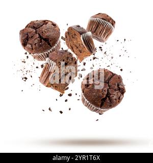 Chocolate chip muffins flying with chocolate chips on white background. Stock Photo
