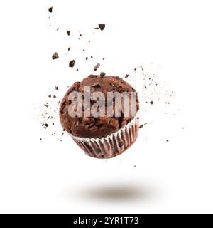 Chocolate chip muffin jumping with chocolate chips on white background. Stock Photo