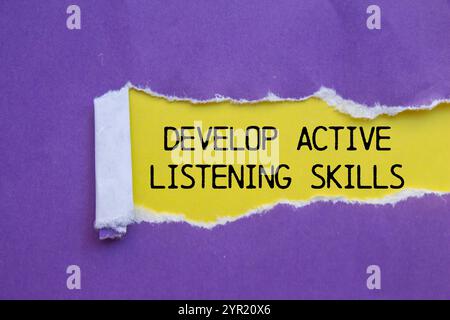 Develop active listening skills message written on ripped torn red ...
