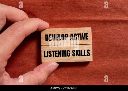 Develop active listening skills message written on wooden block with ...