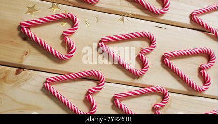 Candy cane hearts and stars image over wooden background Stock Photo