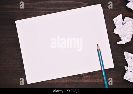 Blank white paper with crumpled balled up paper on office desk, mockup copy space Stock Photo