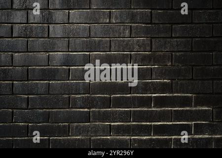 Black brick wall, old and worn surface texture as grunge background and design element Stock Photo