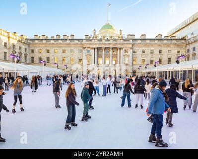 People skating at the Somerset House outdoor ice skating rink, London, UK Stock Photo