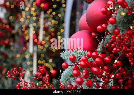 New Year background, Christmas tree branches with red balls on blurred lights background Stock Photo