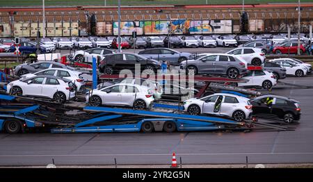 Zwickau, Germany. 02nd Dec, 2024. New cars are loaded for delivery in a parking lot on the Volkswagen factory premises. The Zwickau plant exclusively produces all-electric vehicles of the VW Group brands. Credit: Hendrik Schmidt/dpa/Alamy Live News Stock Photo