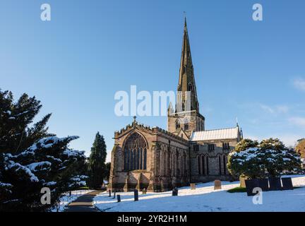 St Oswald's Church after a fall of snow, Ashbourne, Derbyshire Stock Photo