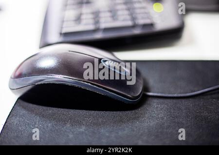 computer stylish wired mouse on a dark background. Orgonomics of the hand and wrist when working at the computer Stock Photo