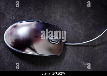 computer stylish wired mouse on a dark background. Orgonomics of the hand and wrist when working at the computer Stock Photo