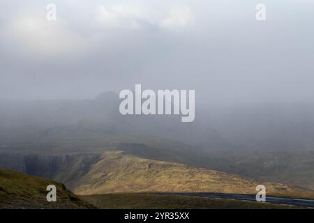 Icelandic mountains shrouded in clouds, creating a mystical atmosphere Stock Photo