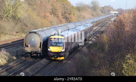 Arriva Cross Country Class 170 Turbostar DMU 170639 with a Nottingham to Birmingham New Street service passing an oil tank train at North Stafford Jn. Stock Photo
