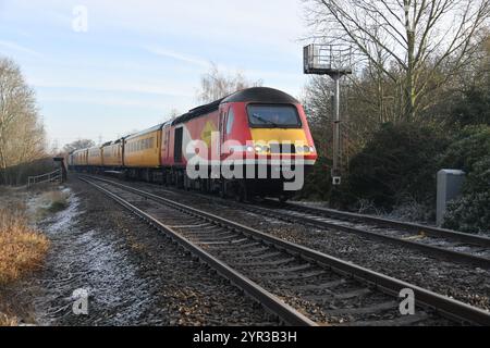 Short formed New Measurement Train with Colas liveried Class 43 Power Car 43272 leading approaching Findern Lane Level Crossing South Derbyshire Stock Photo