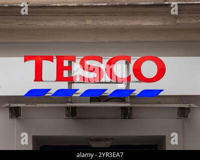 Tesco logo sign of the British supermarket chain. The retailer for groceries has many stores in Czech Republic. Close up of a shop front. Stock Photo