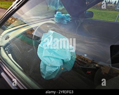 Interior of a automobile involved in a front crash with a deployed steering column airbag. Stock Photo