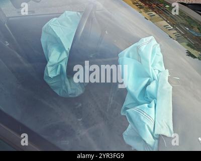 Interior of a automobile involved in a front crash with a deployed steering column airbag. Stock Photo