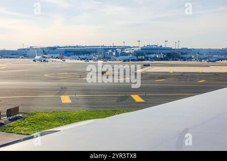 Wide view of Newark Liberty International Airport terminal with multiple airplanes, including United Airlines, parked near gates. New Jersey, USA. Stock Photo