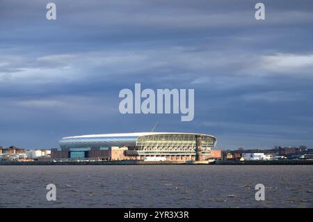 Everton's new Bramley Moore stadium lit up in the early morning sunshine, viewed from across the river. Stock Photo