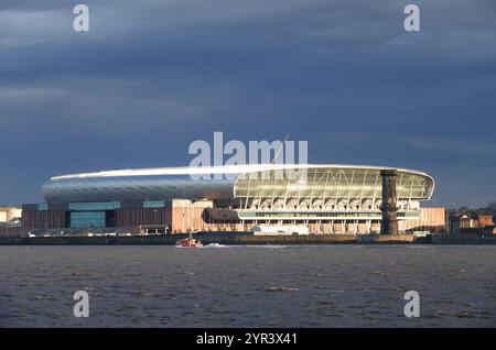 Everton's new Bramley Moore stadium lit up in the early morning sunshine, viewed from across the river. Stock Photo