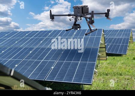 Industrial drone inspects solar panels. Stock Photo