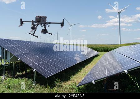 Industrial drone inspects solar panels. Stock Photo