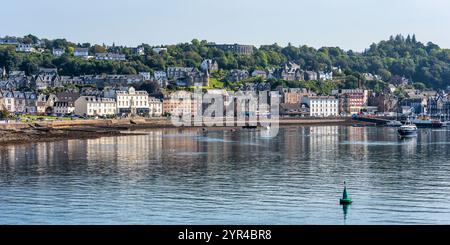 Panoramic view of Oban seafront, with the McCaig’s Tower on Battery Hill overlooking the town, in Oban, Argyll and Bute, Scotland, UK Stock Photo