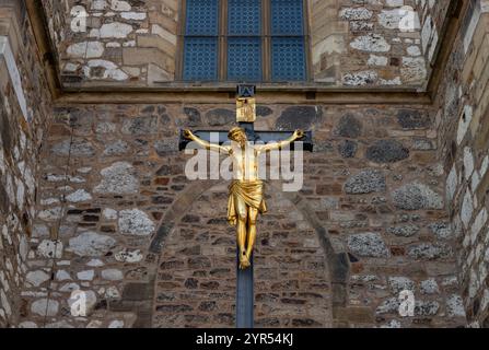 A picture of a golden Jesus statue outside of the Cathedral of Saint Peter and Paul, Brno. Stock Photo