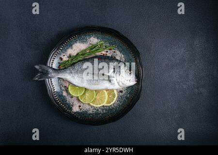 Fresh, raw dorado fish, on a dark blue background, top view, two pieces, no people Stock Photo
