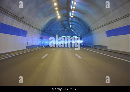 Modern, well-lit motorway tunnel with blue illuminated walls and a clear asphalt road, Zurich, Switzerland, Europe Stock Photo