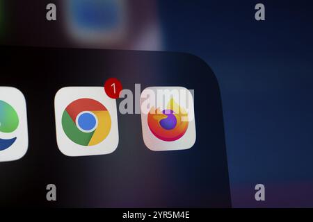 A close up of an iPhone screen displaying the Google Chrome, mozilla firefox app icon. Stock Photo