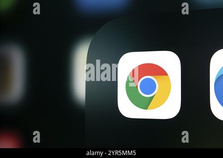 A close up of an iPhone screen displaying the Google Chrome app icon. Stock Photo