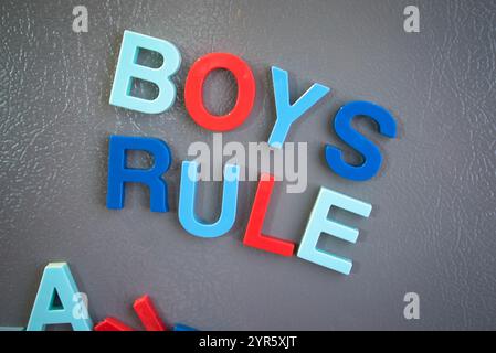 Colorful Magnetic Letters Spell 'Boys Rule' on Refrigerator Door Stock Photo