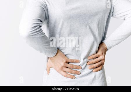 Renal colic and back pain. Man suffers from lower back pain Stock Photo